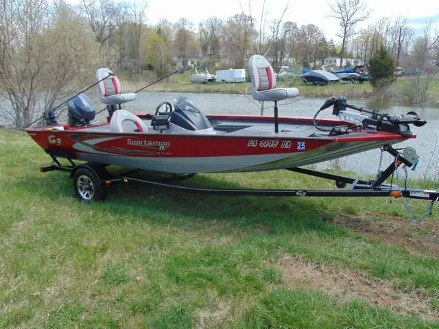 The Image of 2018 G3 Sportsman 17 fishing boat on trailer by a lake. - 1