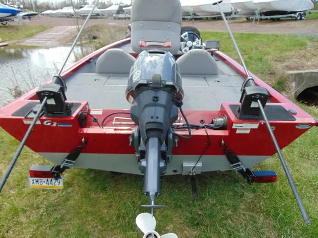 Slide: The Image of 2018 G3 Sportsman 17 boat with motor, parked on grass near water. - 3