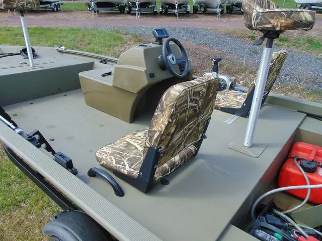Slide: The Image of 2020 Tracker GRIZZLY® 1648 SC boat interior with camo seats and steering console. - 6
