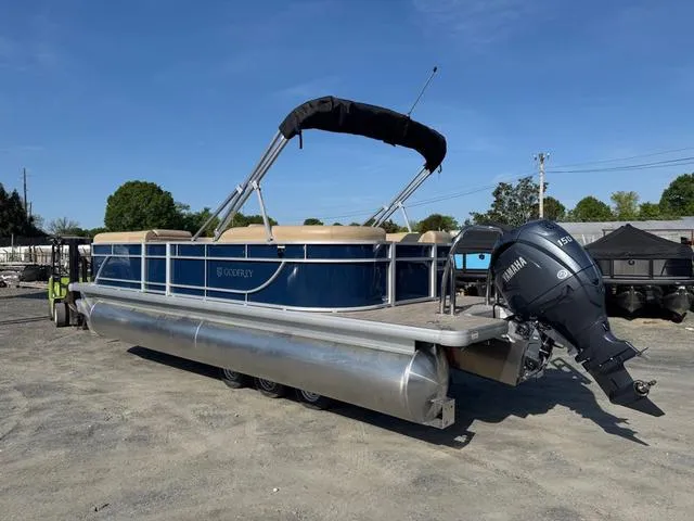 Slide: The Image of 2025 Godfrey Sweetwater 2286 SBX Tritoon with 150 Yamaha engine on display outdoors. - 1