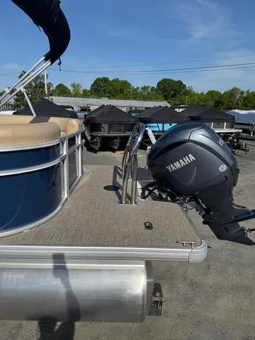 Slide: The Image of 2025 Godfrey Sweetwater 2286 SBX Tritoon with Yamaha 150 engine, docked outdoors. - 8