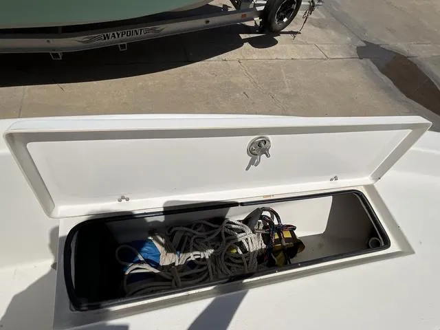 Slide: The Image of Open storage compartment on a 2007 Blazer 2220 Pro boat, containing ropes and equipment. - 12