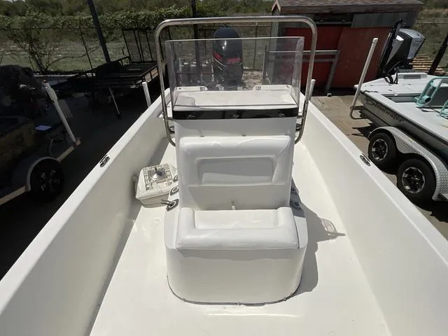 Slide: The Image of 2007 Blazer 2220 Pro boat interior with white seating and steering console. - 13