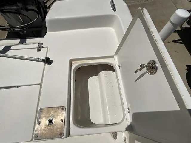 Slide: The Image of Open storage compartment on a 2007 Blazer 2220 Pro boat deck. - 22