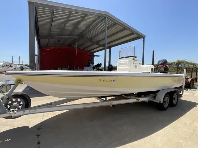 Slide: The Image of 2007 Blazer 2220 Pro boat on trailer under metal canopy. - 3