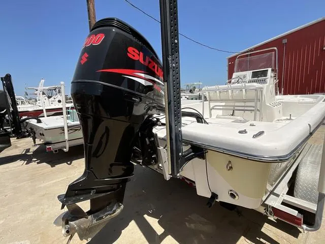 Slide: The Image of 2007 Blazer 2220 Pro boat with Suzuki outboard motor, parked outdoors. - 6
