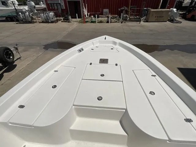 Slide: The Image of Bow of 2007 Blazer 2220 Pro boat with storage compartments, docked outdoors. - 7