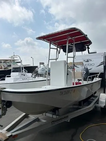 Slide: The Image of 1984 Boston Whaler 17 Montauk boat on trailer, red canopy, parked outdoors. - 3