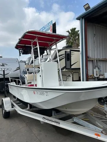 Slide: The Image of 1984 Boston Whaler 17 Montauk boat on trailer, parked near RVs and palm tree. - 5