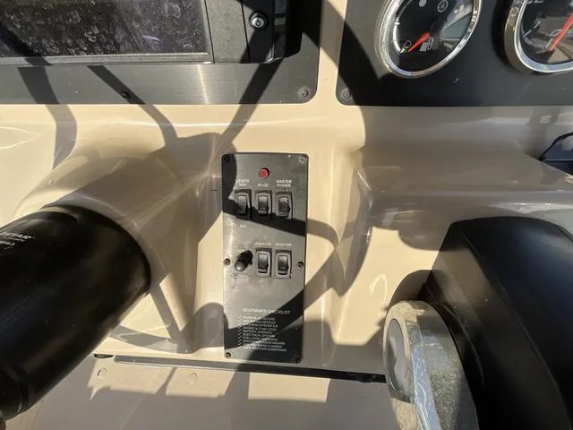 Slide: The Image of Control panel of 2023 G3 BAY20GX boat with switches and gauges. - 14