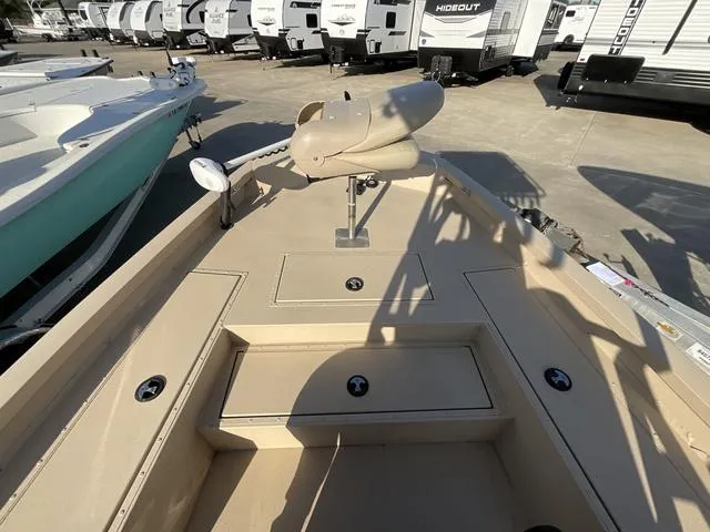 Slide: The Image of 2023 G3 BAY20GX boat deck with storage compartments, parked near RVs. - 8