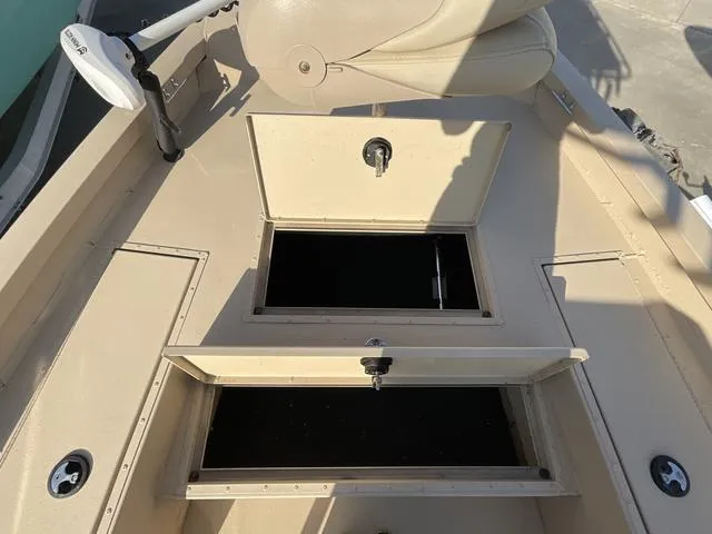 Slide: The Image of 2023 G3 BAY20GX boat deck with open storage compartments and beige seating. - 9