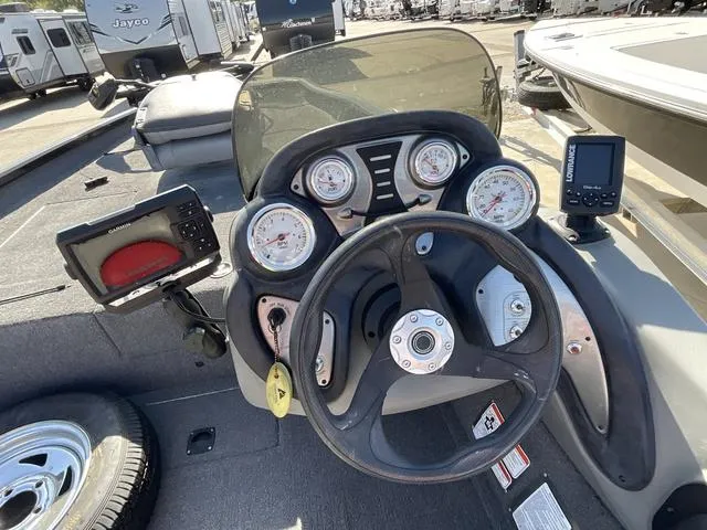 Slide: The Image of 2015 Tracker Pro 175 boat dashboard with gauges and navigation equipment. - 11