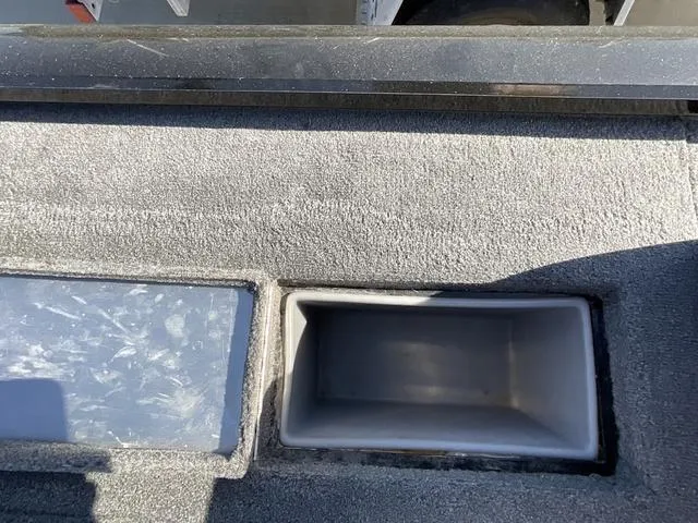 Slide: The Image of 2015 Tracker Pro 175 boat storage compartments, open and empty, with textured interior. - 13