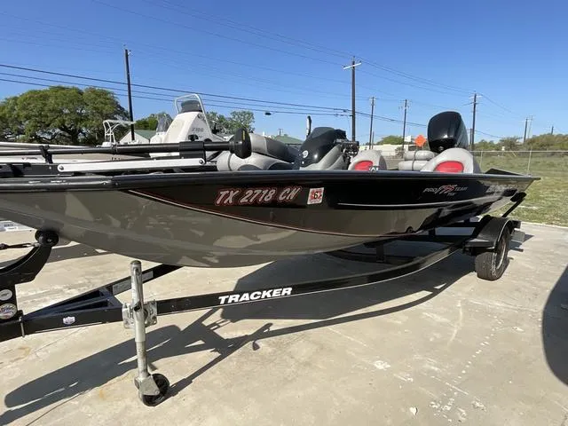 Slide: The Image of 2015 Tracker Pro 175 boat on trailer, parked outdoors under clear blue sky. - 3