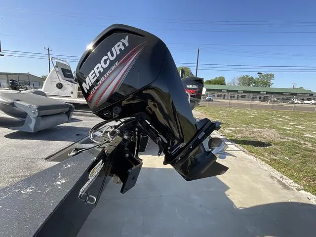 Slide: The Image of 2015 Tracker Pro 175 boat with Mercury outboard motor in a sunny outdoor setting. - 4