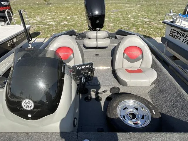 Slide: The Image of 2015 Tracker Pro 175 boat interior with seats, steering console, and Garmin device. - 9