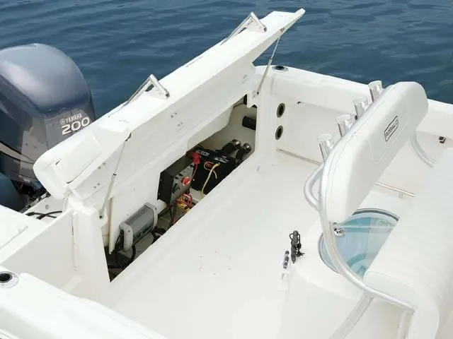 Slide: The Image of 2009 Robalo Center Console R220 boat interior with Yamaha 200 engine, open storage compartment. - 4