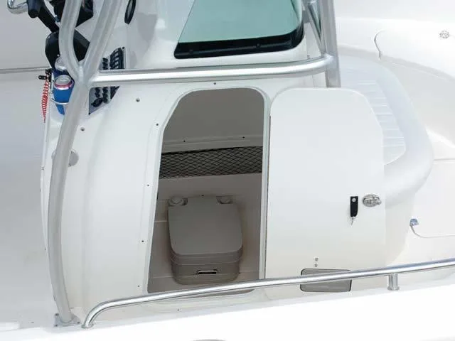 Slide: The Image of 2009 Robalo Center Console R220 boat with open storage compartment and portable toilet. - 7
