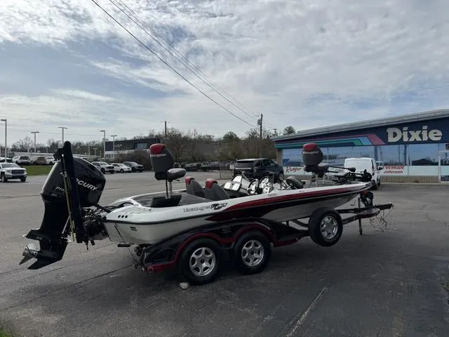 Slide: The Image of 2006 Ranger Z19 boat on trailer in parking lot, featuring Mercury outboard motor. - 6