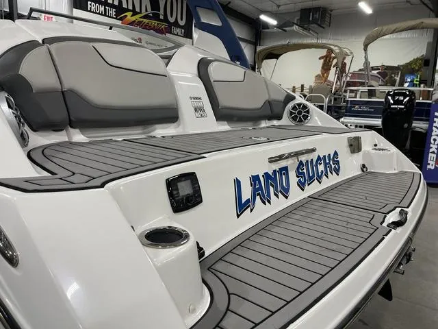 Slide: The Image of 2018 Yamaha Boats 212 Limited S with custom "Land Sucks" decal in showroom. - 10