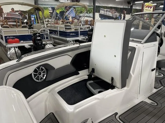 Slide: The Image of 2018 Yamaha Boats 212 Limited S interior with open storage compartment and speaker. - 15