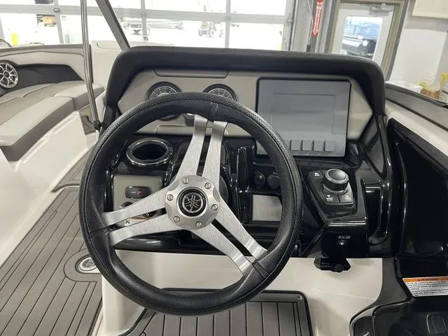 Slide: The Image of 2018 Yamaha Boats 212 Limited S dashboard with steering wheel and controls. - 25