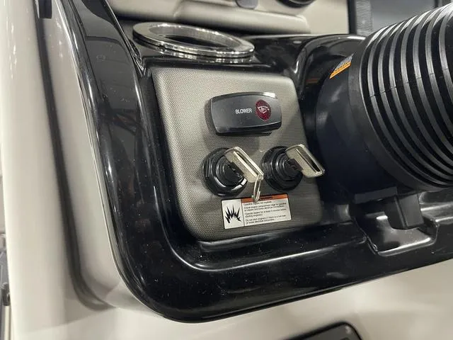 Slide: The Image of Control panel of 2018 Yamaha Boats 212 Limited S with ignition keys and blower switch. - 28