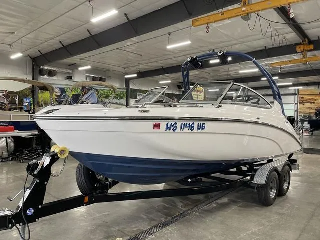 Slide: The Image of 2018 Yamaha Boats 212 Limited S on trailer in indoor showroom. - 6