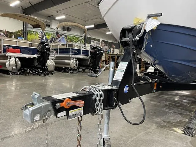 Slide: The Image of Yamaha Boats 2018 212 Limited S on trailer in showroom with other boats. - 7