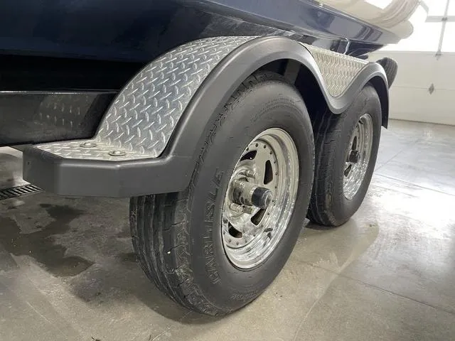 Slide: The Image of Trailer wheels of a 2018 Yamaha Boats 212 Limited S in a garage. - 9