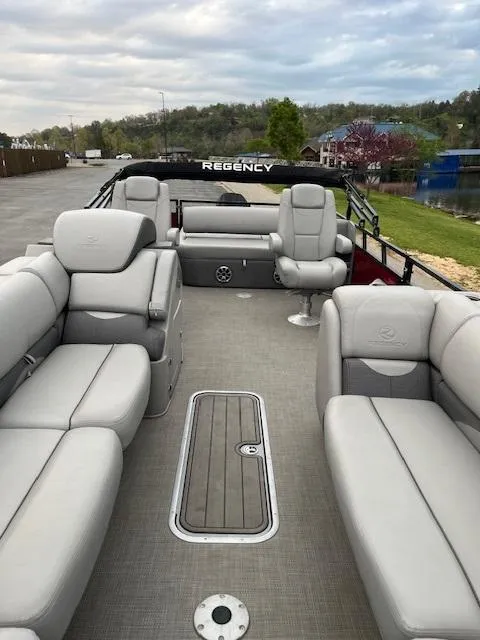 Slide: The Image of 2024 Regency 250 DL3 pontoon boat with spacious seating and modern design. - 14