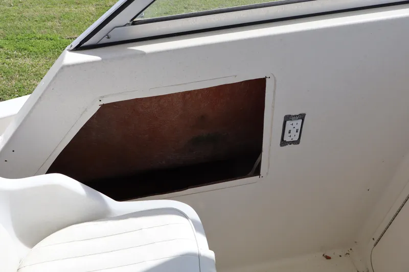 Slide: The Image of 2005 Sea Boss 235 Walkaround interior detail with open storage compartment. - 10