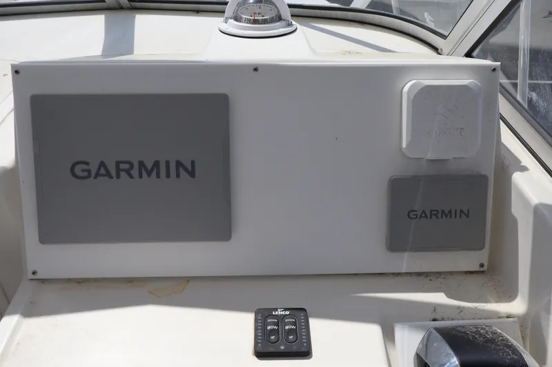 Slide: The Image of 2005 Sea Boss 235 Walkaround dashboard with Garmin navigation equipment. - 13
