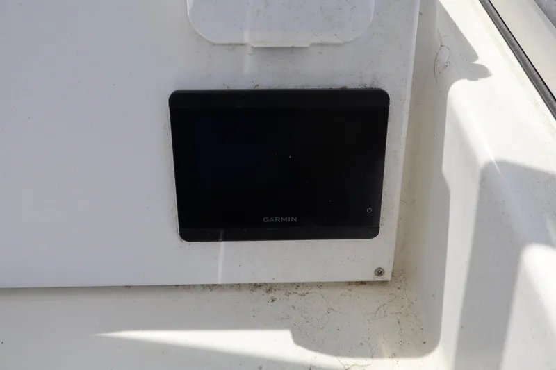 Slide: The Image of Garmin device on 2005 Sea Boss 235 Walkaround boat dashboard. - 14