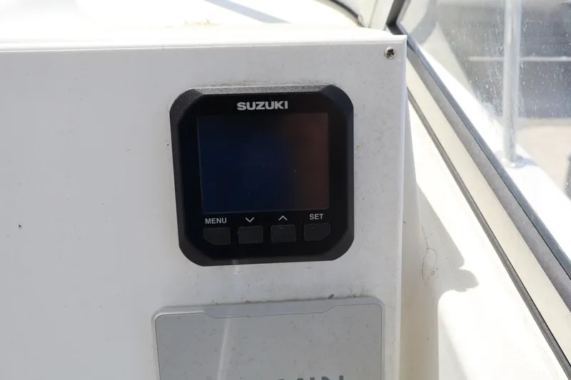 Slide: The Image of Suzuki display panel on 2005 Sea Boss 235 Walkaround boat dashboard. - 15