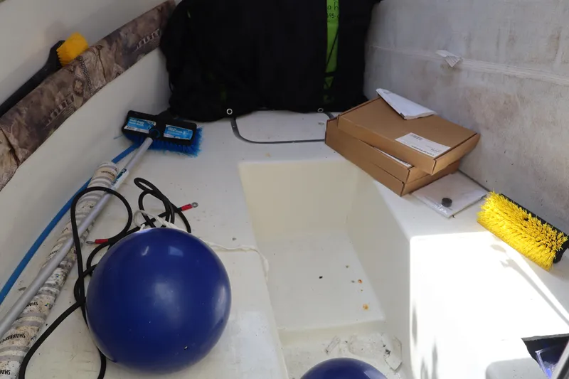 Slide: The Image of 2005 Sea Boss 235 Walkaround boat interior with cleaning supplies and equipment. - 18