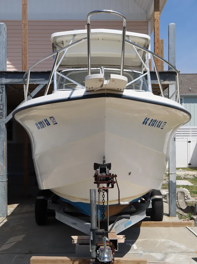 Slide: The Image of 2005 Sea Boss 235 Walkaround boat on trailer, front view in storage. - 2