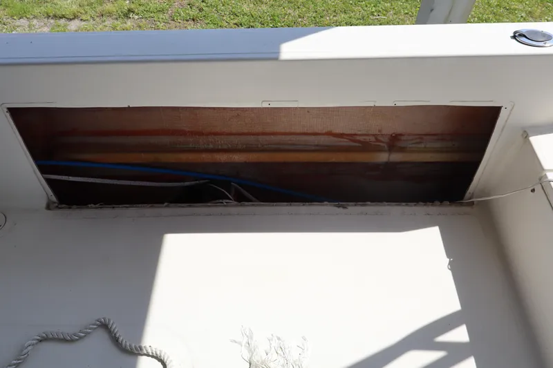 Slide: The Image of 2005 Sea Boss 235 Walkaround boat interior with open storage compartment. - 6