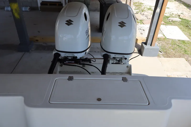 Slide: The Image of Twin Suzuki outboard engines on a 2005 Sea Boss 235 Walkaround boat. - 7