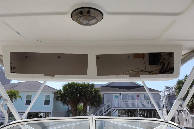 Slide: The Image of 2005 Sea Boss 235 Walkaround boat interior with open storage compartments. - 9