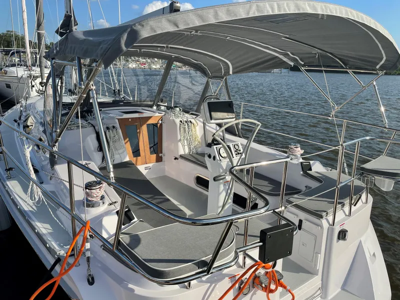 Slide: The Image of 2021 Catalina C355 sailboat with canopy, docked on a sunny day. - 1