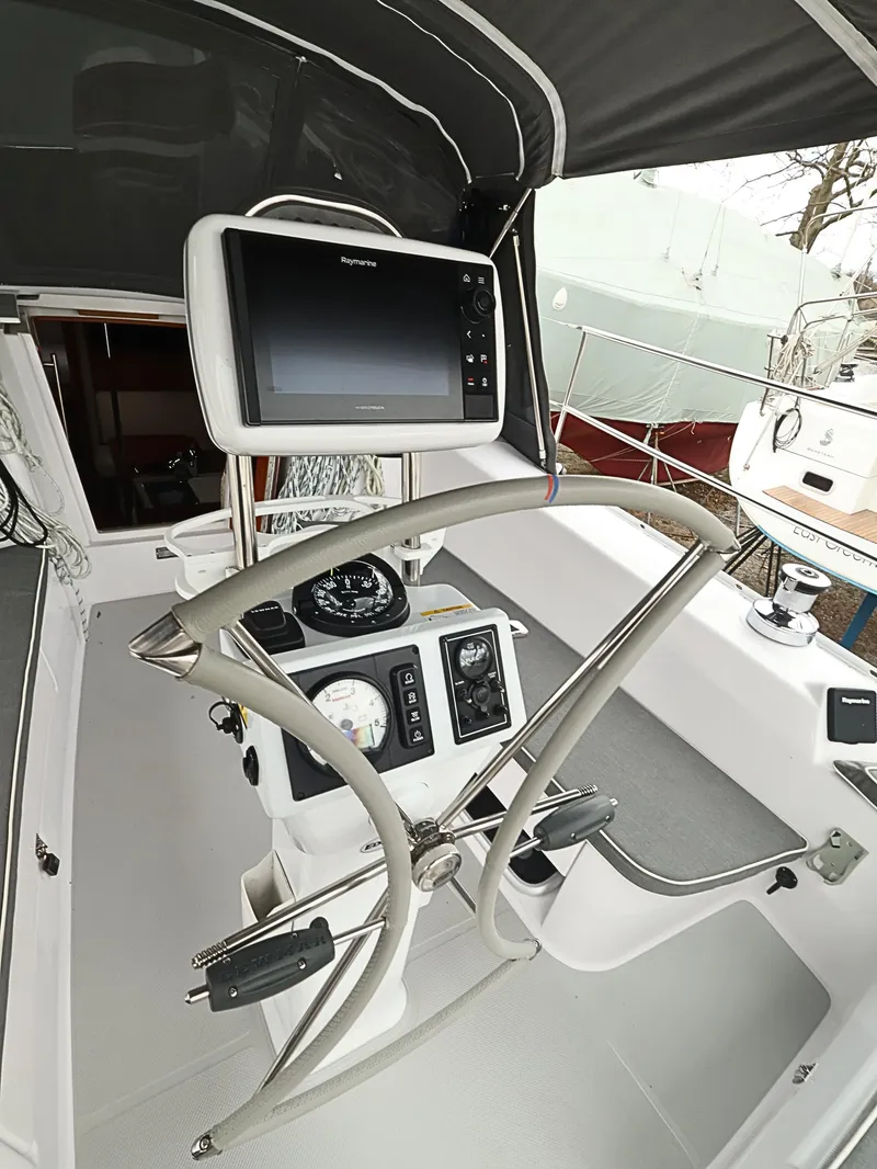 Slide: The Image of Cockpit of 2021 Catalina C355 sailboat with navigation equipment and steering wheel. - 13