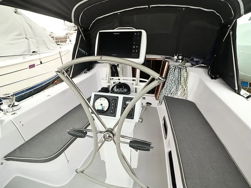 Slide: The Image of Cockpit of 2021 Catalina C355 sailboat with steering wheel and navigation equipment. - 14
