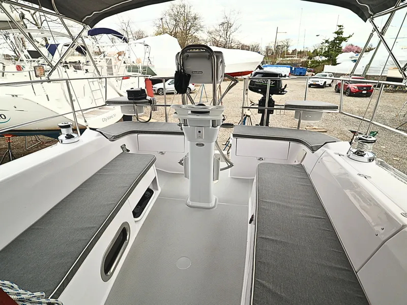 Slide: The Image of 2021 Catalina C355 sailboat cockpit with gray seating, steering wheel, and marina background. - 17