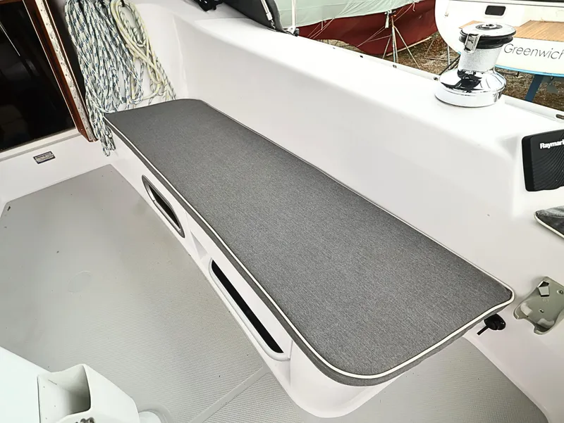 Slide: The Image of Catalina C355 2021 sailboat cockpit with cushioned seating and winch. - 18