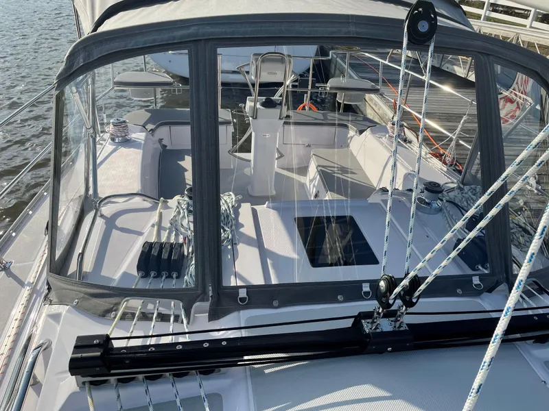Slide: The Image of 2021 Catalina C355 sailboat cockpit with ropes and clear canopy, docked on calm water. - 2