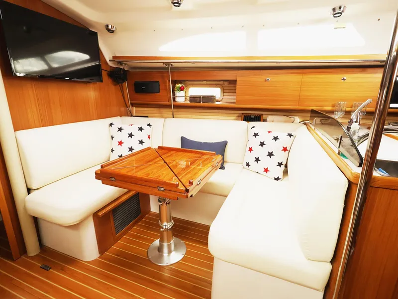 Slide: The Image of Interior of 2021 Catalina C355 yacht with cozy seating and wooden table. - 24