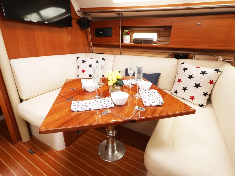 Slide: The Image of Elegant dining area in 2021 Catalina C355 yacht with wooden table and star-patterned cushions. - 25