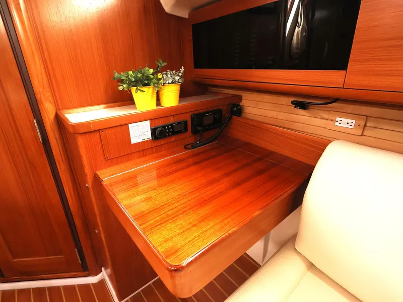 Slide: The Image of 2021 Catalina C355 yacht interior with wooden desk, plants, and seating. - 31